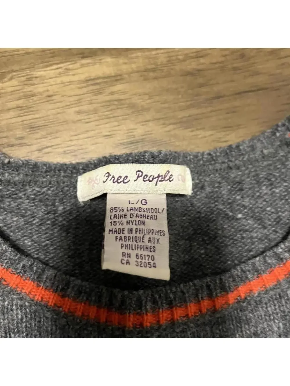 Free people grey sweater with red stripes and flower pattern